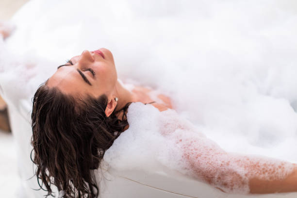 Bathtub with bubbles being drained - Tips for eliminating bathtub bubbles for a peaceful soak